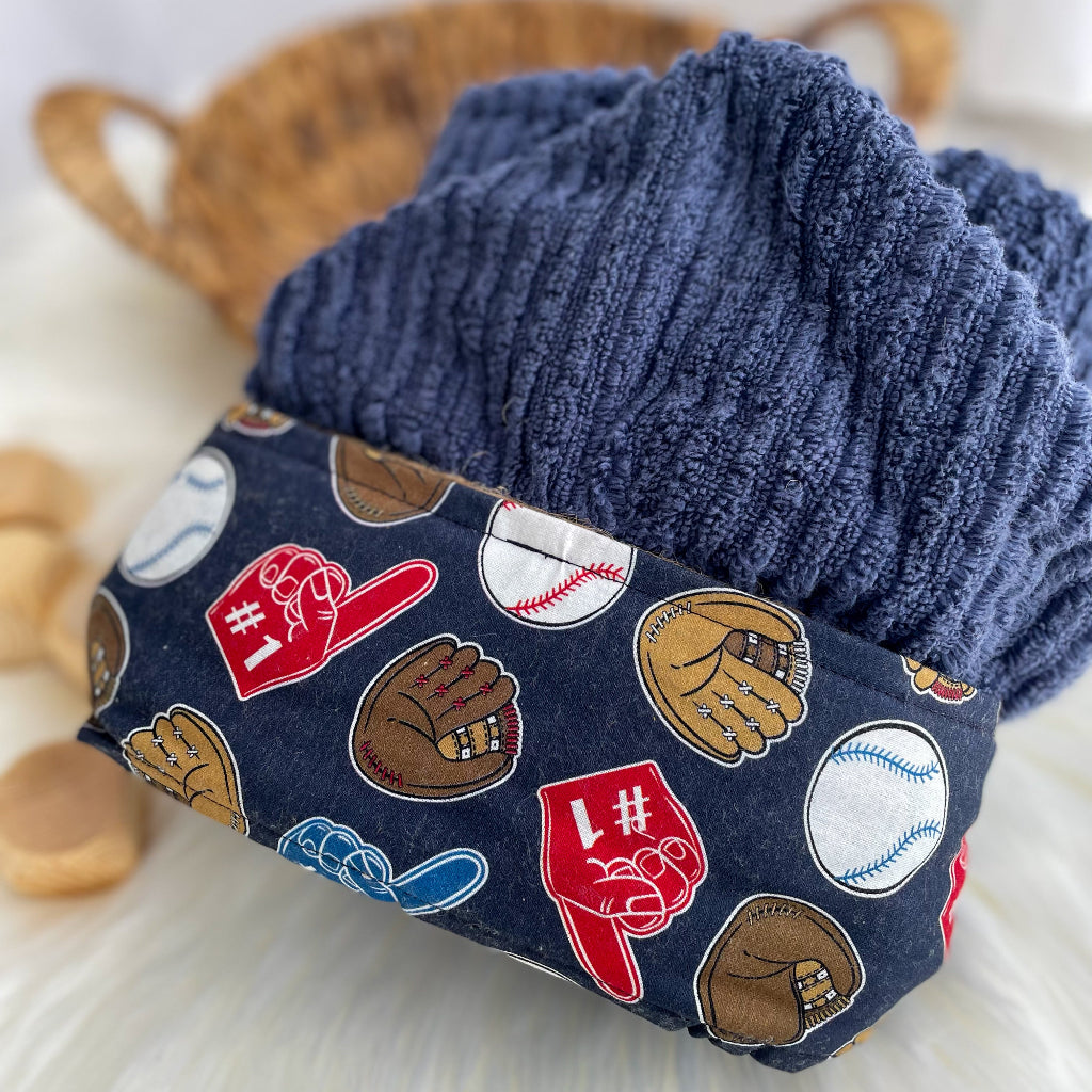 Navy blue hooded towel featuring fabric with ball gloves baseballs foam fingers