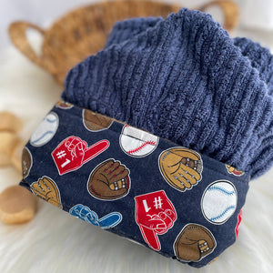 Navy blue hooded towel featuring fabric with ball gloves baseballs foam fingers