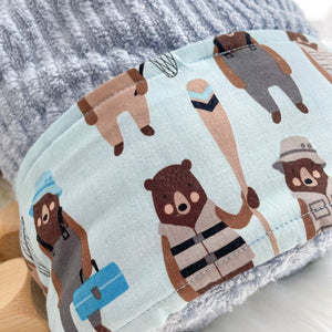Fabric with bear illustrations on a light blue background, featuring a bear with a hat and tackle box , another with a tackle box and net