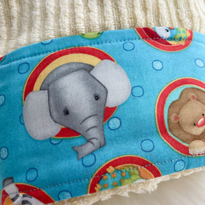 Fabric with elephant and lion designs on a blue background