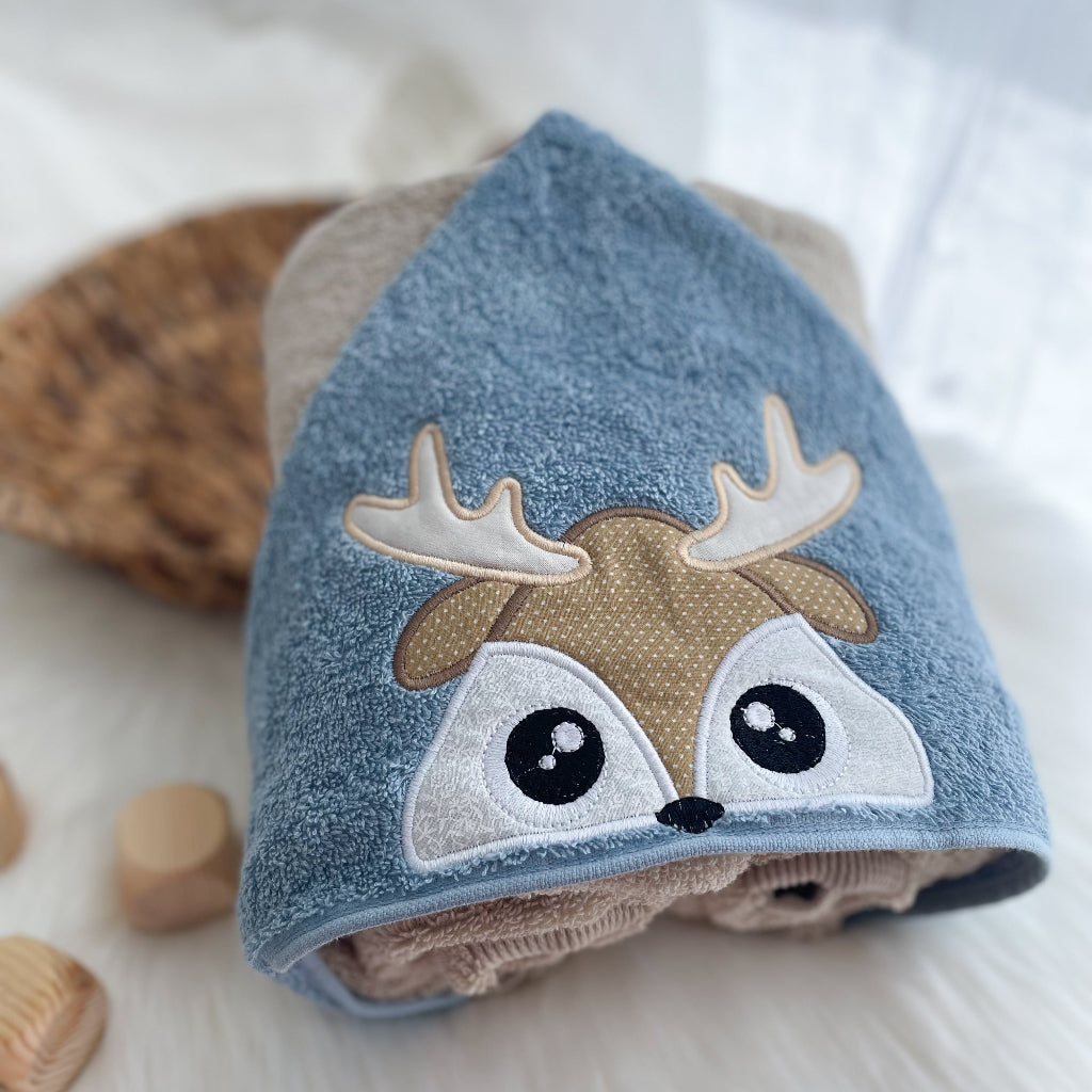 Children's hooded towel with deer design on a soft background