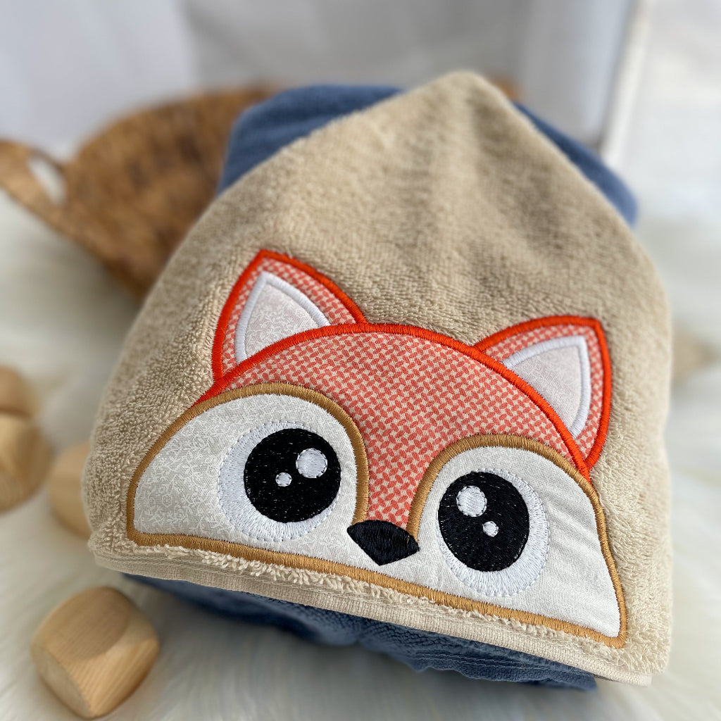 Kids peeker towel with a fox face stitched on the hood