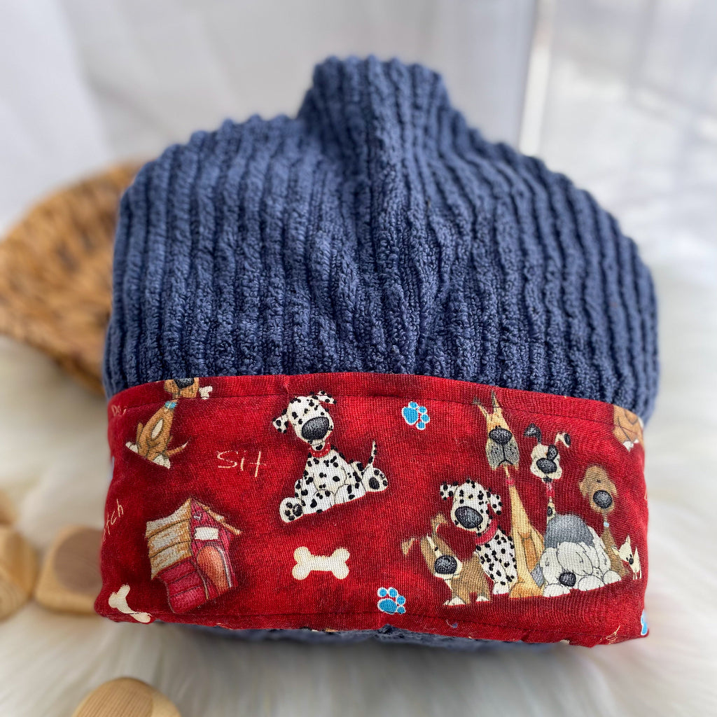 Blue hooded towel with a red band featuring dog illustrations on a white background