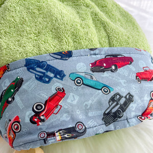 Lime green hooded towel folded with a fabric trim featuring classic cars close up