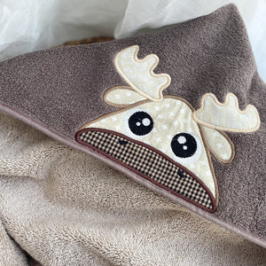 Brown towel with a moose applique on a white background