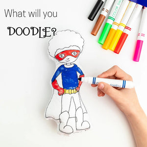 Superhero stuffie Coloring Activity Kit partially colored with washable markers in the backgroundTiny Owls Gift Co