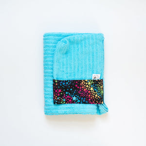 Blue towel with a colorful star pattern on a white background