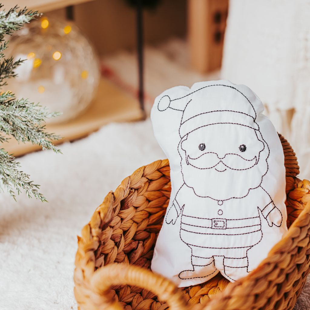 Tiny Owls Gift Co santa doodle pillow sitting in woven basket