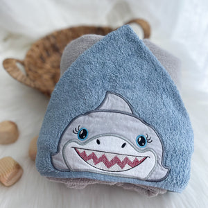 Shark appliqued face on a blue towel hood
