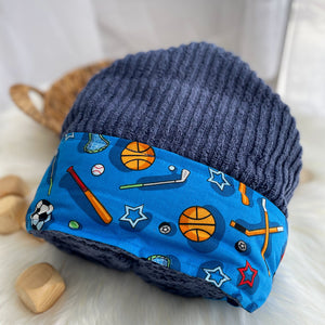 Blue hooded towel with sports-themed design on a white surface