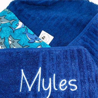 Royal blue kids hooded towel with Myles embroidered sharks