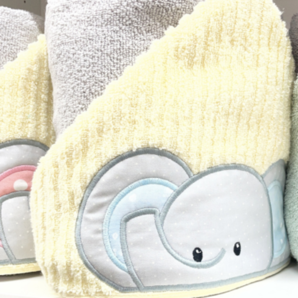 yellow towel hood with a grey elephant and blue inner ears
