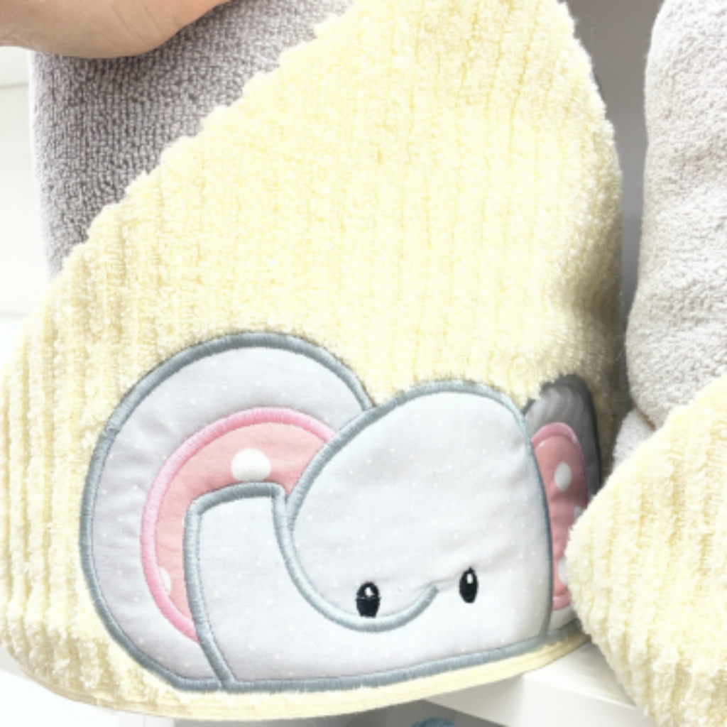 yellow hood with an elephant face and pink polka dot ears